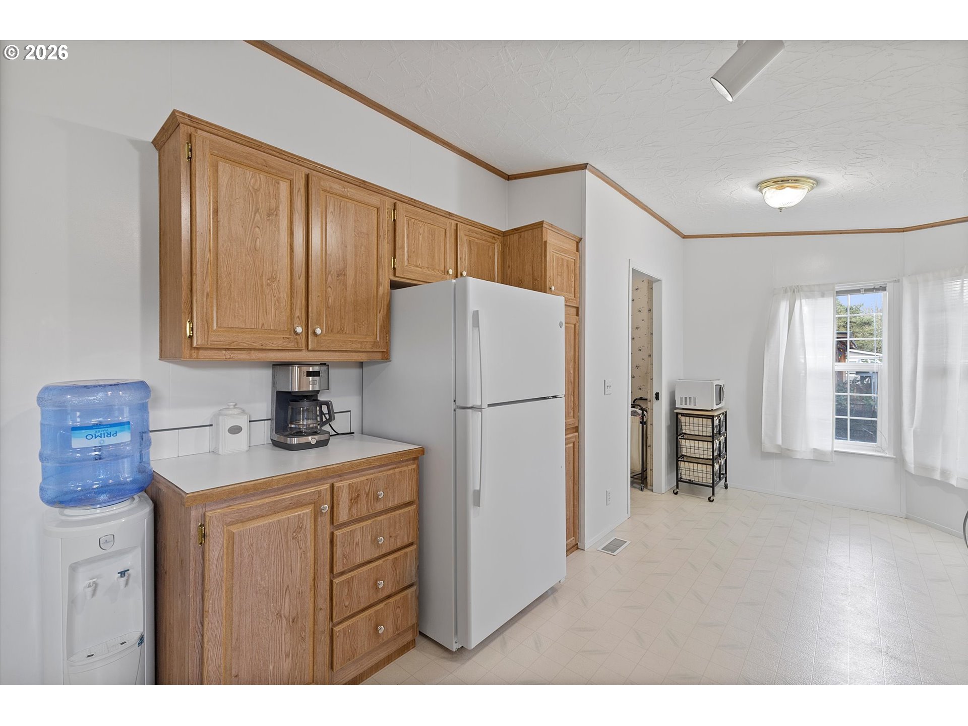 32935 Southwest Oakview Court Cornelius, OR 97113 - Photo 14 of 47 a kitchen with a refrigerator a sink and cabinets