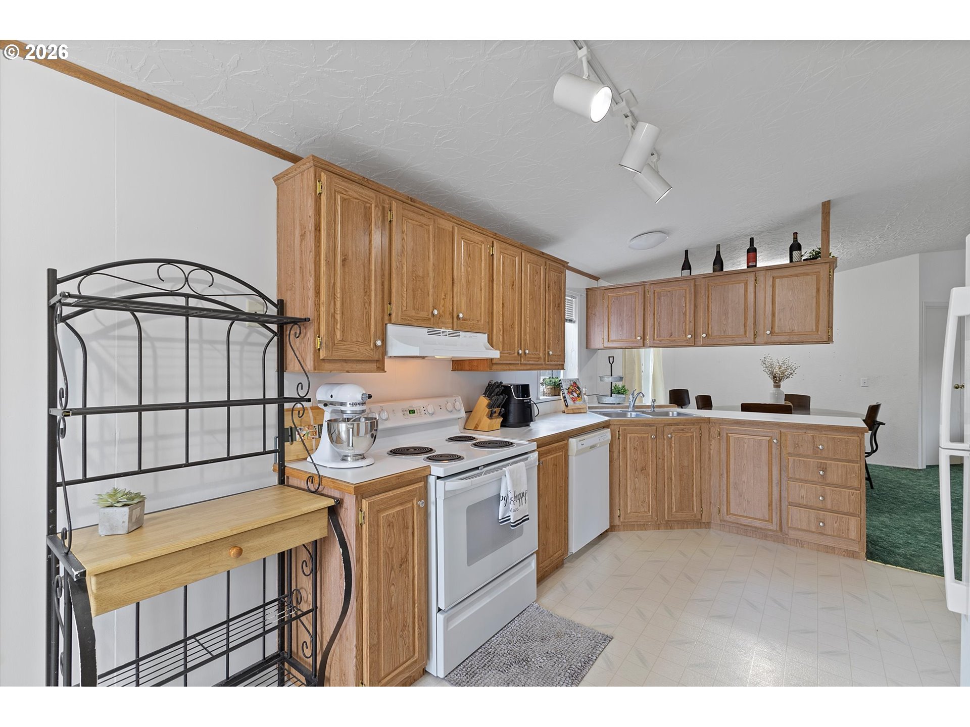 32935 Southwest Oakview Court Cornelius, OR 97113 - Photo 15 of 47 a kitchen with a stove a sink cabinets and a window