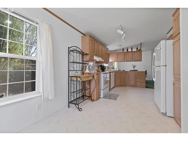 a view of kitchen with furniture and windows