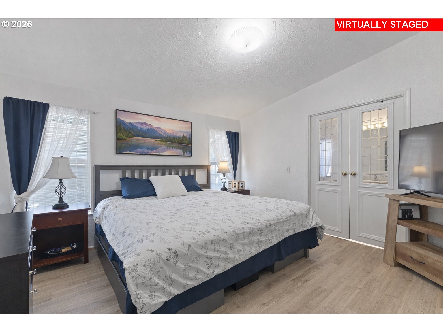 32935 Southwest Oakview Court Cornelius, OR 97113 - Photo 21 of 47 a bedroom with a bed a mirror on dresser and a flat screen tv