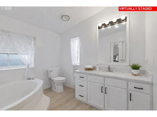 a bathroom with a double vanity sink and a bathtub