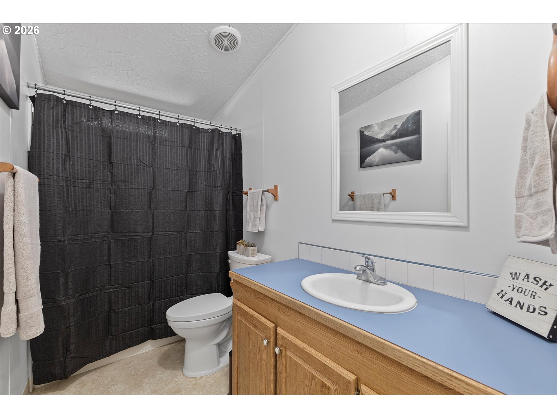 32935 Southwest Oakview Court Cornelius, OR 97113 - Photo 35 of 47 a bathroom with a sink toilet a mirror and shower curtain