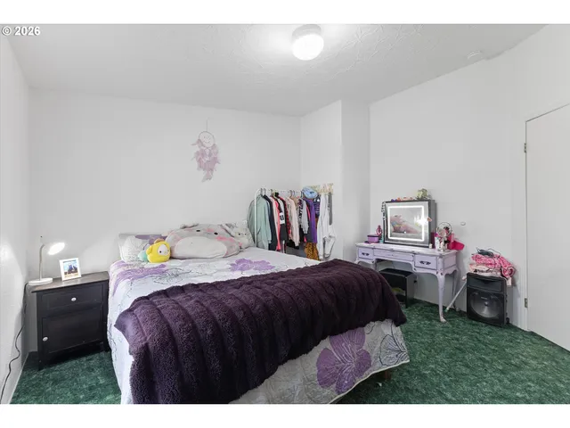 a bedroom with a bed and a desk