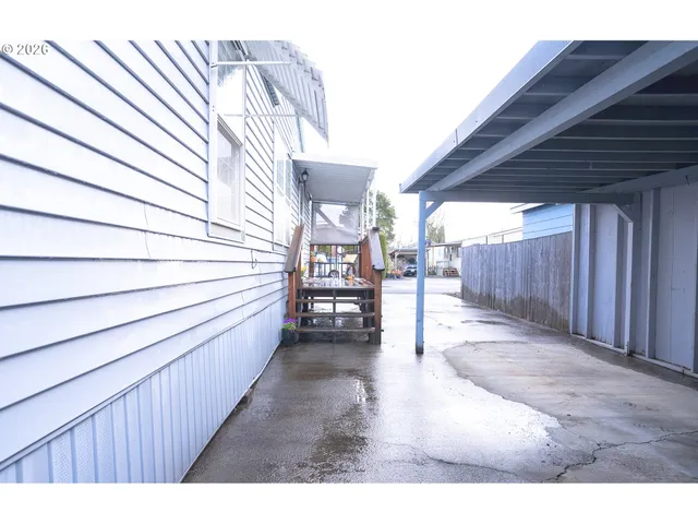 a view of a backyard with sitting area and wooden fence