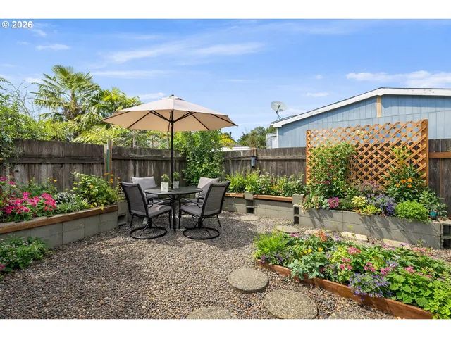 a view of a patio with table and chairs under an umbrella