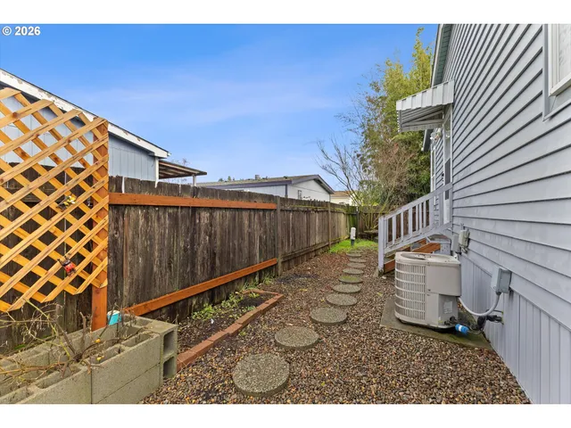 a backyard of a house with wooden fence