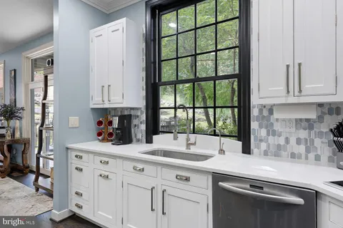 a kitchen with stainless steel appliances granite countertop a stove sink and cabinets