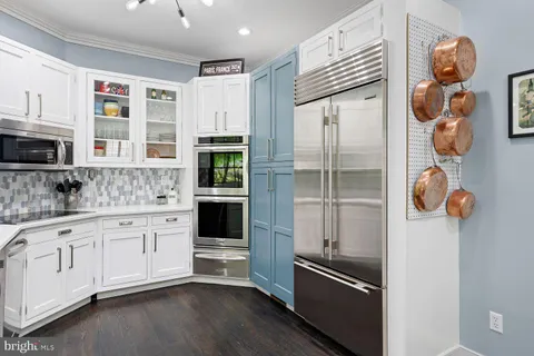 a kitchen with appliances cabinets and a window