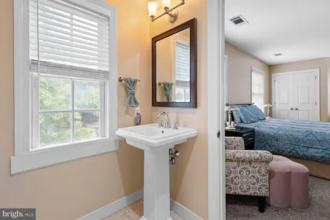 a en suite bathroom with sink and mirror
