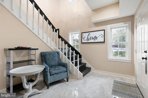 a view of entryway and hall with wooden floor