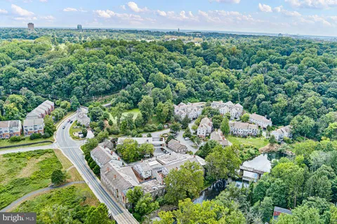 an aerial view of multiple houses with yard