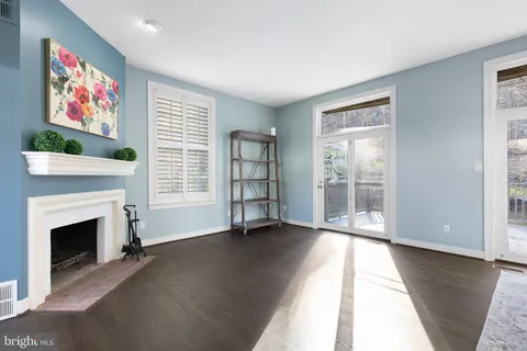 a living room with furniture large window and a fireplace