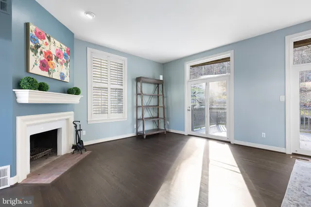 a living room with furniture large window and a fireplace