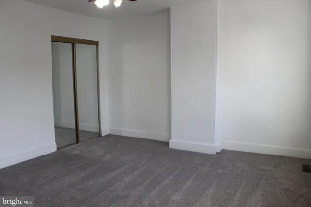 an empty room with closet area
