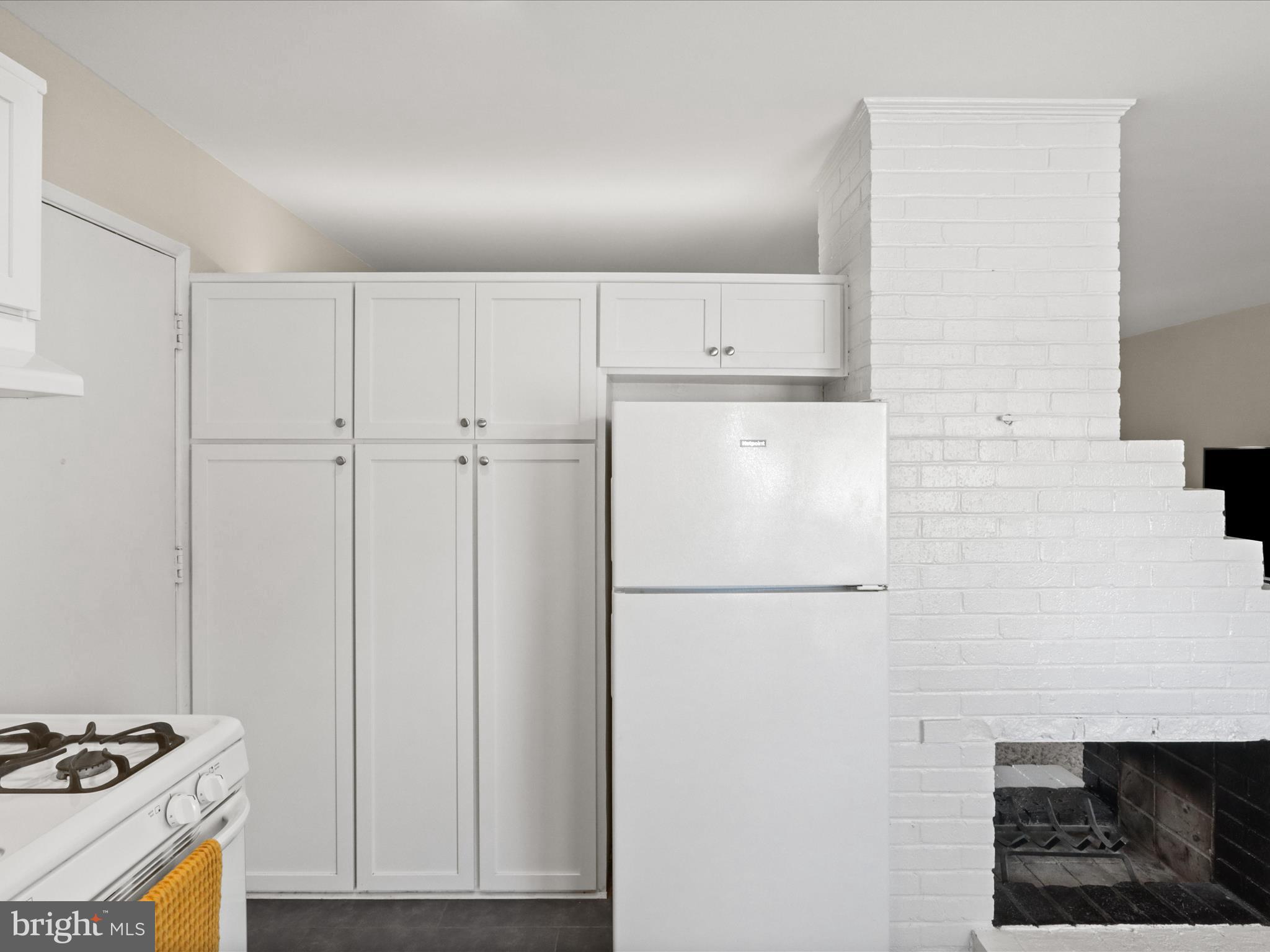 5908 Hanover Avenue Springfield, VA 22150 - Photo 13 of 32 a white refrigerator freezer sitting inside of a kitchen