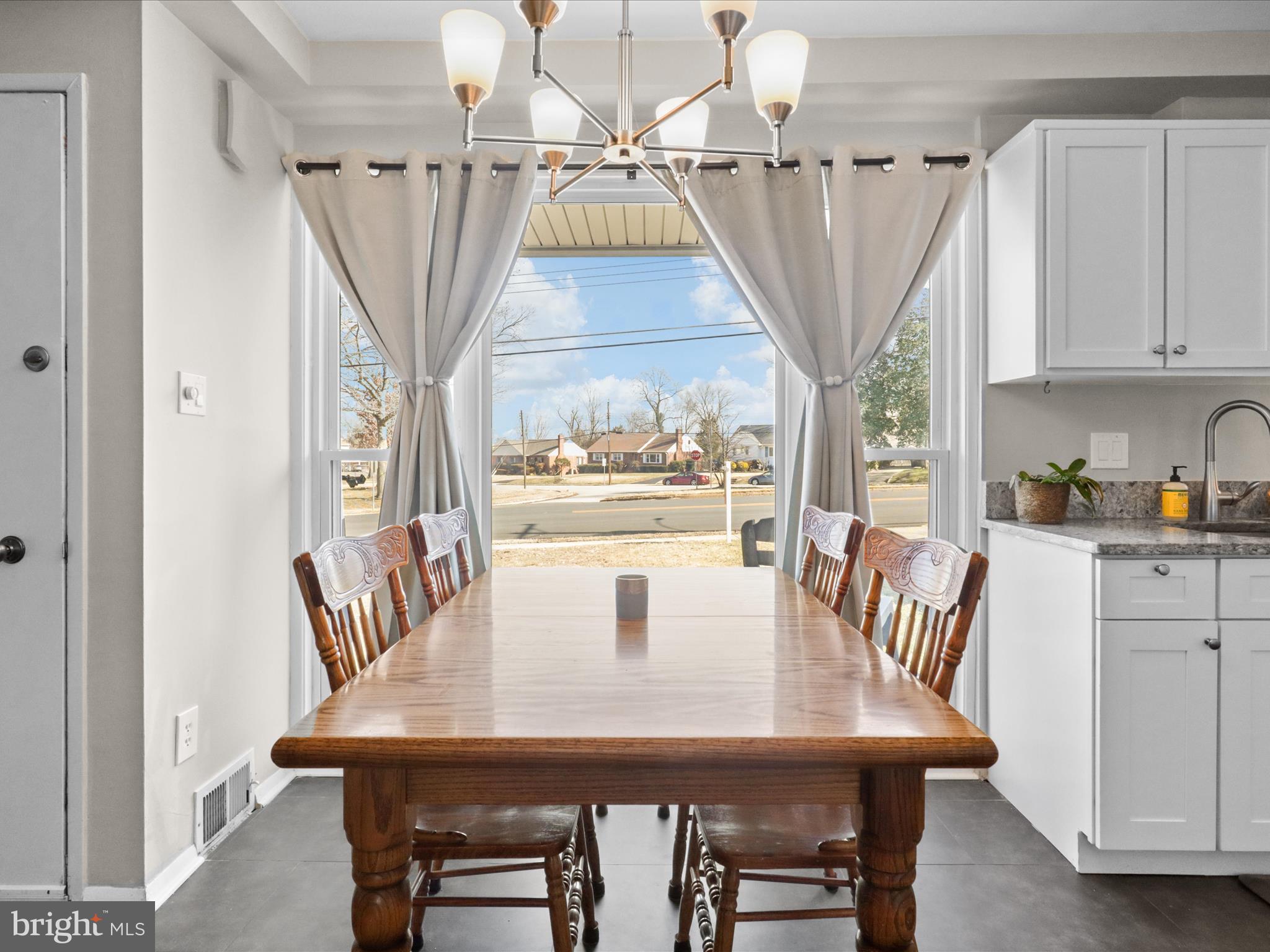 5908 Hanover Avenue Springfield, VA 22150 - Photo 17 of 32 a view of a dining room with furniture and a chandelier