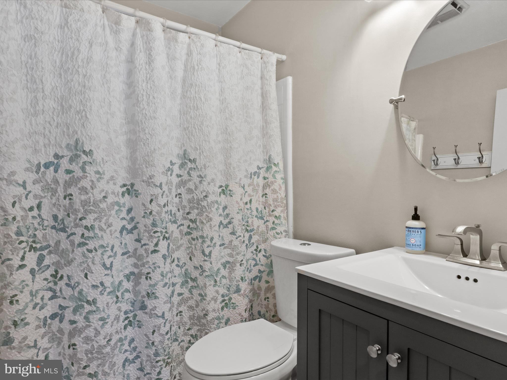 5908 Hanover Avenue Springfield, VA 22150 - Photo 21 of 32 a bathroom with a granite countertop toilet sink and mirror