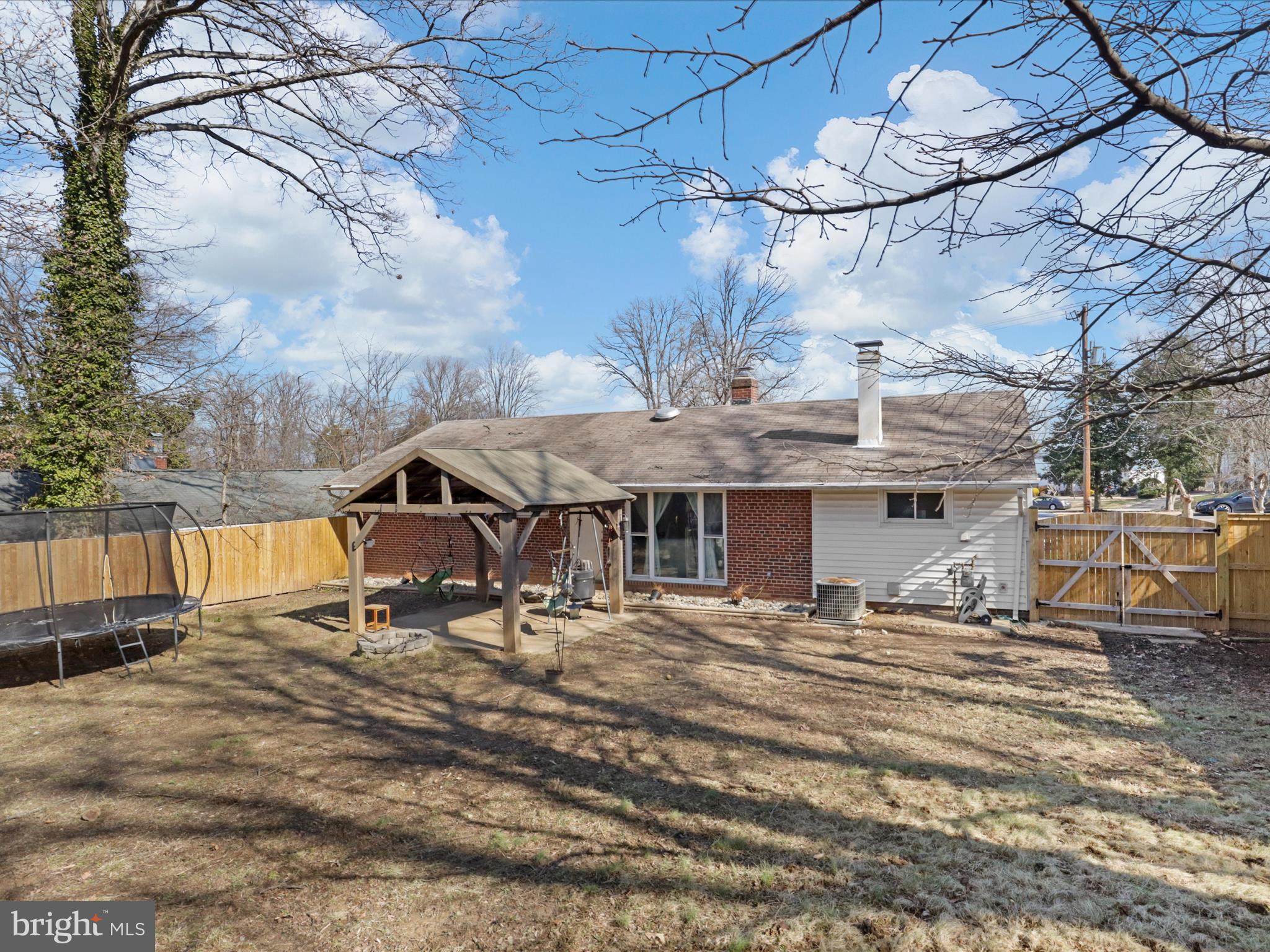 5908 Hanover Avenue Springfield, VA 22150 - Photo 6 of 32 a view of a backyard with table and chairs under an umbrella
