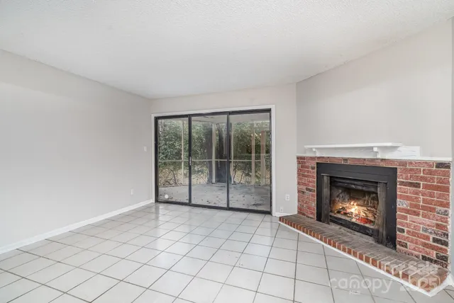a view of an empty room with a fireplace