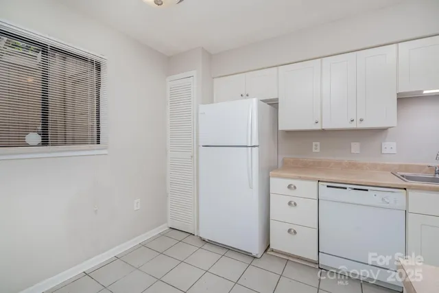 a kitchen with a stove and a refrigerator