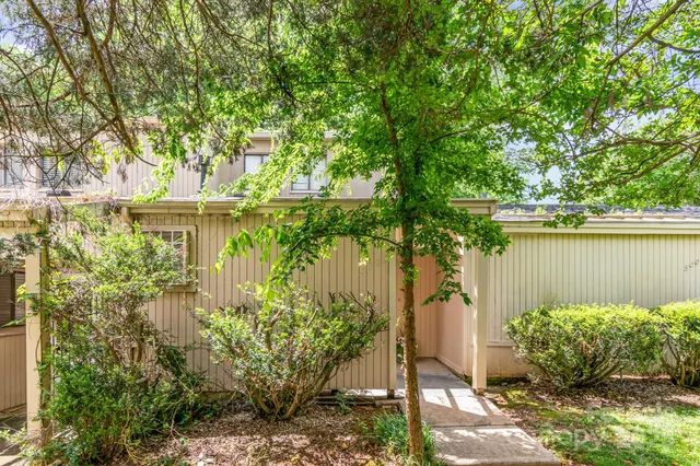 a backyard of a house with lots of green space and lake view