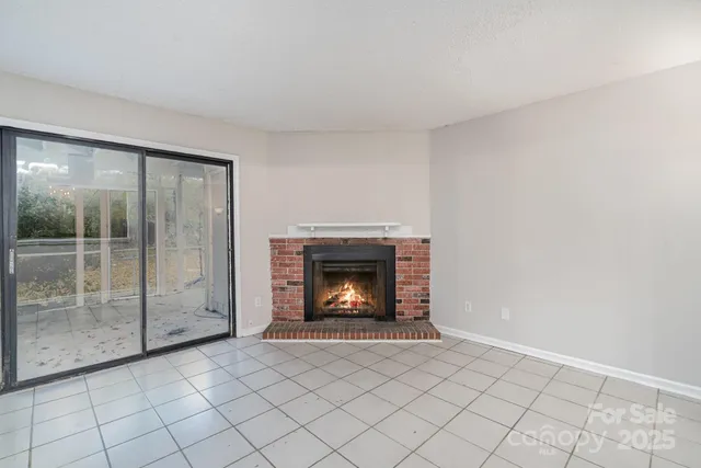 a view of an empty room with a fireplace