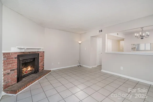 a view of an empty room with a fireplace