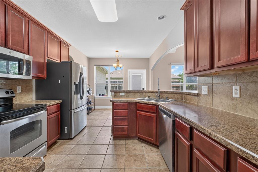 517 Austin Acre Road Sulphur Springs, TX 75482 - Photo 11 of 23 a kitchen with stainless steel appliances granite countertop a sink stove and refrigerator