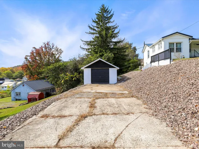 a kitchen with granite countertop a refrigerator and a stove top oven
