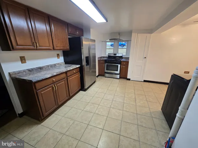 a kitchen with a sink a stove top oven and cabinets