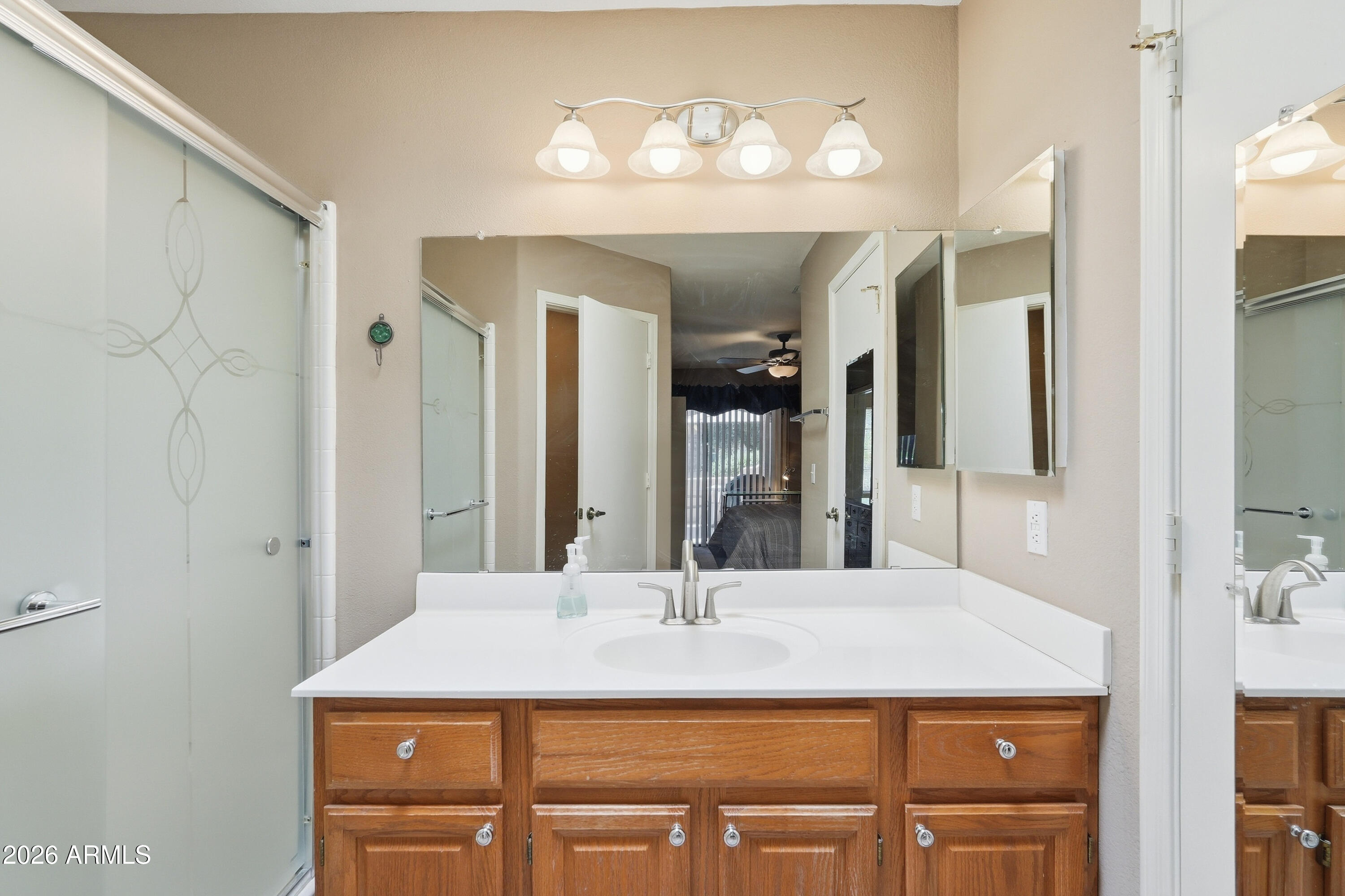 14300 West Bell Road, Unit 387 Surprise, AZ 85374 - Photo 10 of 18 a bathroom with a sink and a mirror