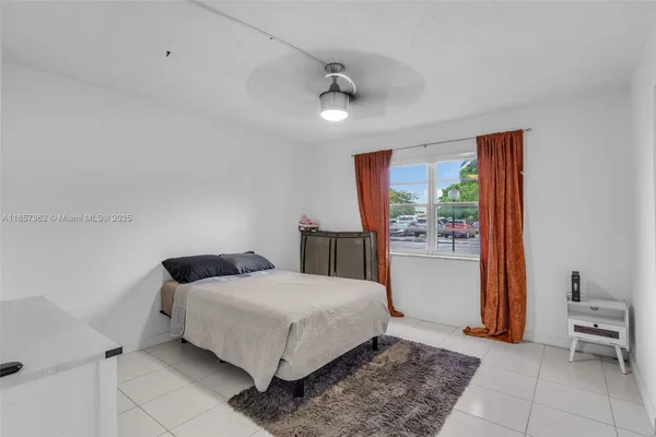 a bedroom with a bed and a view of bathroom