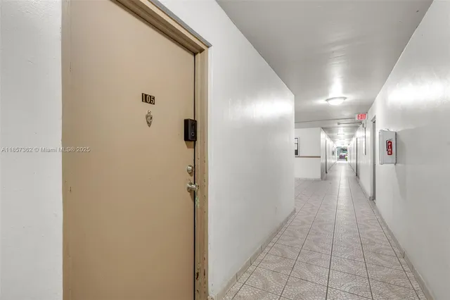 a front view of a house with a yard and potted plants