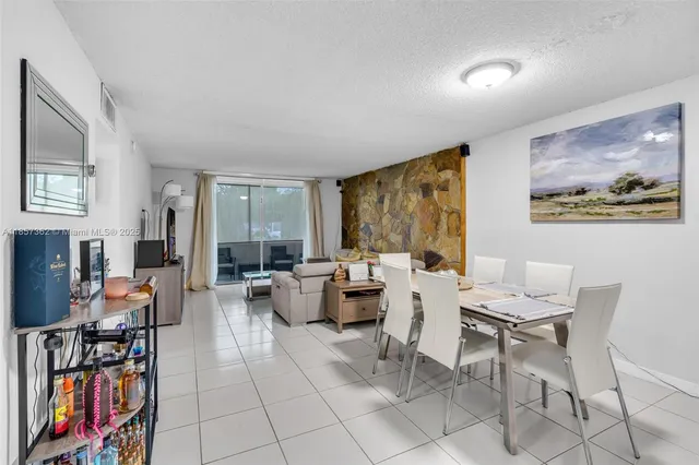 a view of a livingroom with furniture and a book shelf