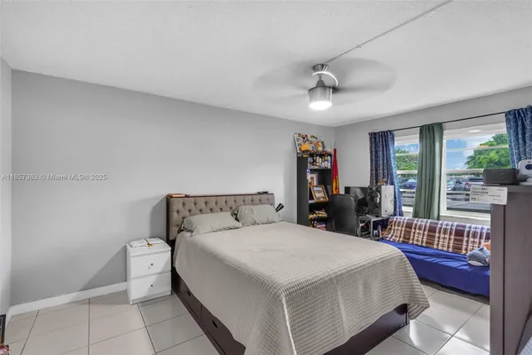 a bed room with a bed and a chandelier