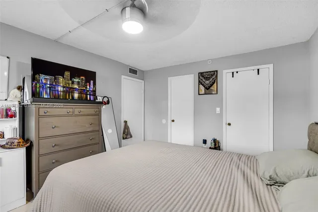 a bedroom with a bed and a television