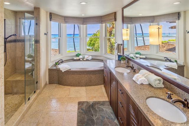 a spacious bathroom with a granite countertop tub sink and mirror