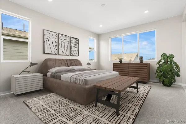 a bedroom with furniture and wooden floor