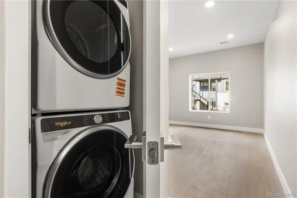 a view of a hallway with washer and dryer