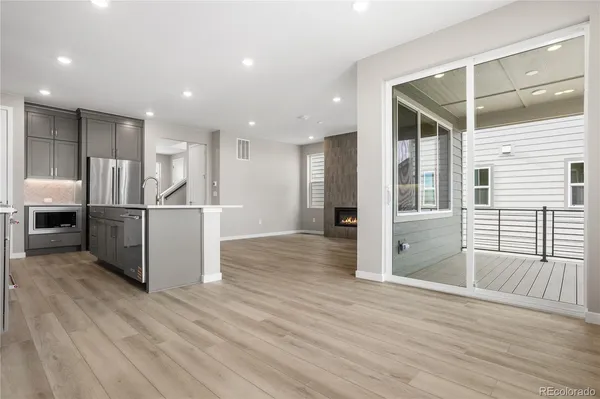a kitchen with stainless steel appliances kitchen island granite countertop a refrigerator and a sink