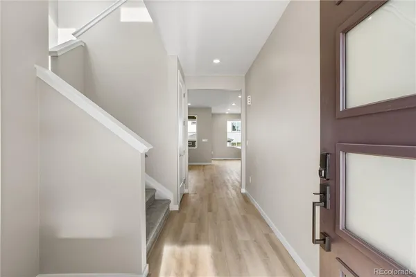 a view of hallway with wooden floor