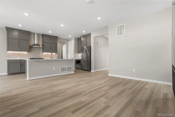 a view of kitchen with wooden floor and electronic appliances