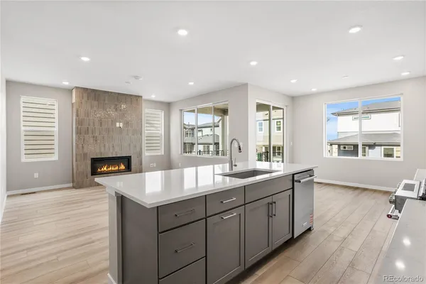 a large kitchen with granite countertop a large counter top and sink