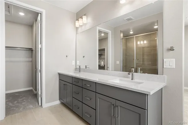a bathroom with a sink double vanity and a mirror