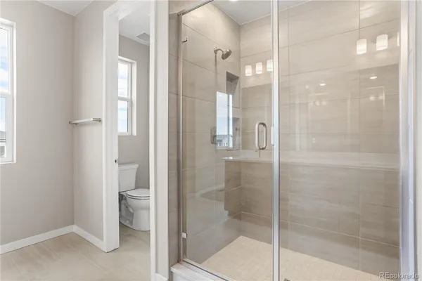 a bathroom with a shower and a glass door