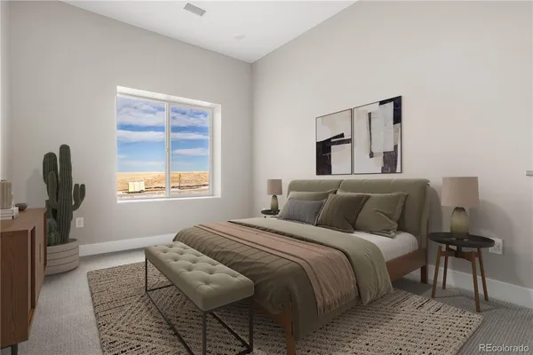 a bedroom with a bed a couch and dresser