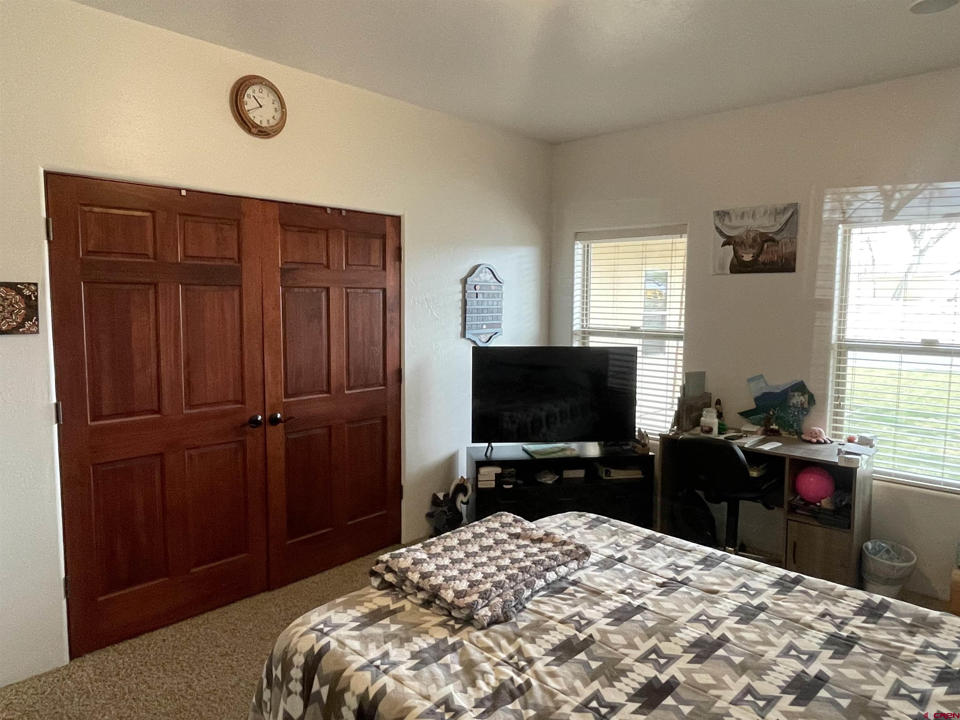 2271 Par Drive Cortez, CO 81321 - Photo 11 of 36 a bedroom with a bed and a flat screen tv