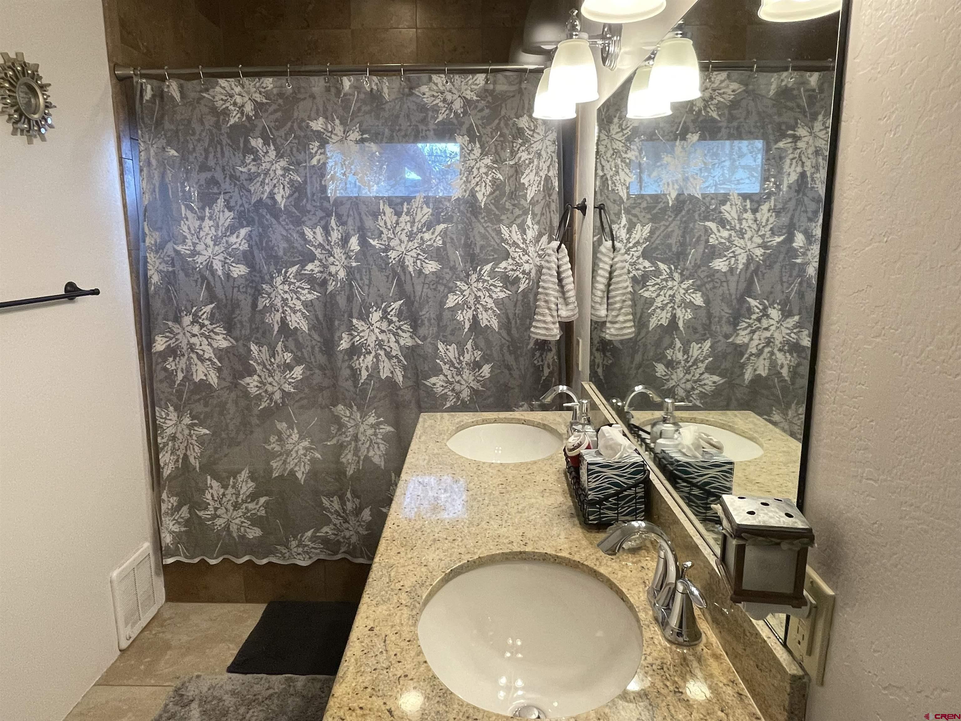 2271 Par Drive Cortez, CO 81321 - Photo 14 of 36 a bathroom with a granite countertop sink a toilet and shower