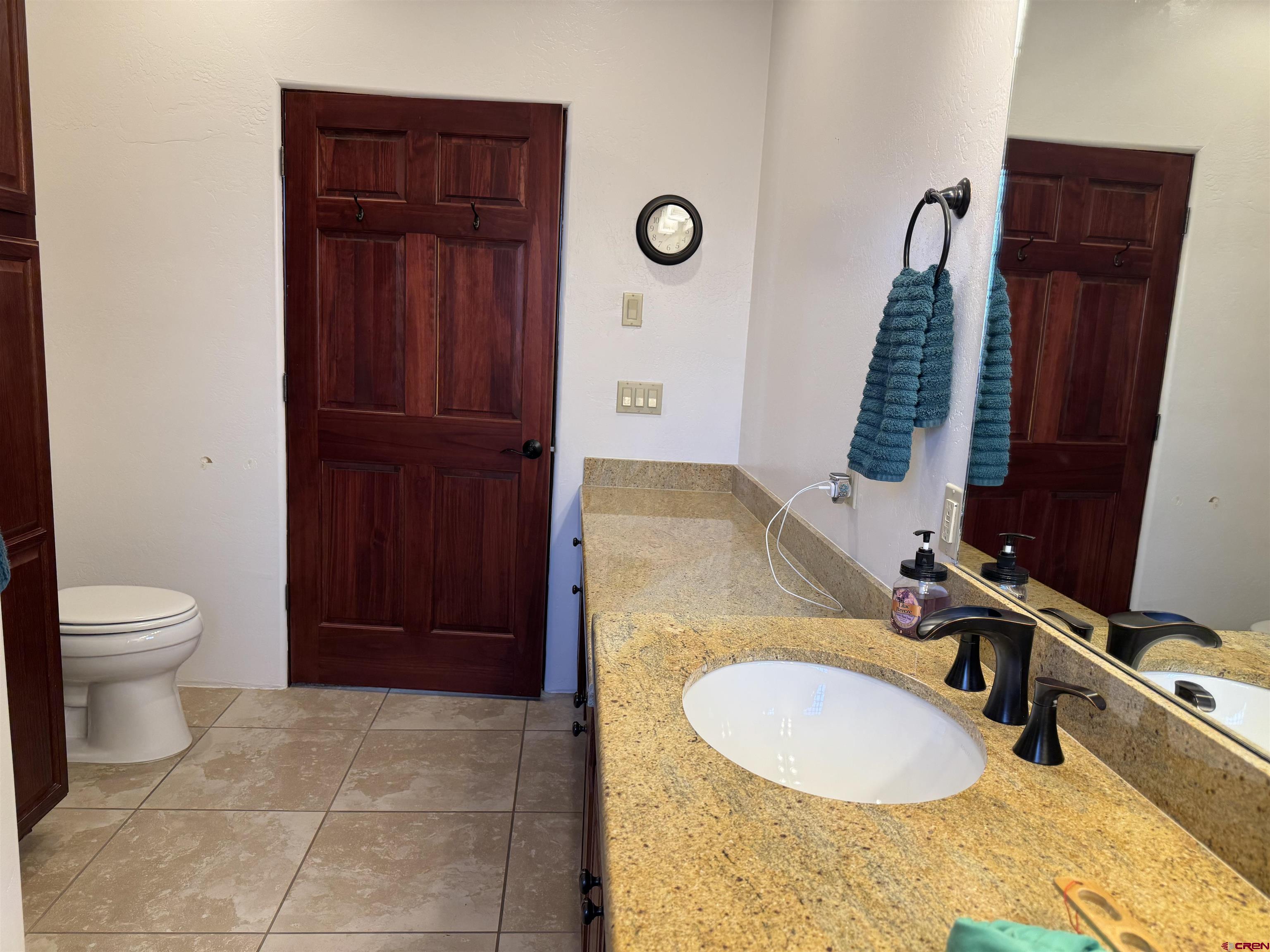 2271 Par Drive Cortez, CO 81321 - Photo 19 of 36 a bathroom with a granite countertop sink and a mirror