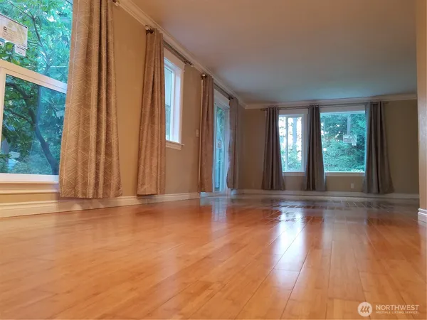 a view of wooden floor and windows in a room